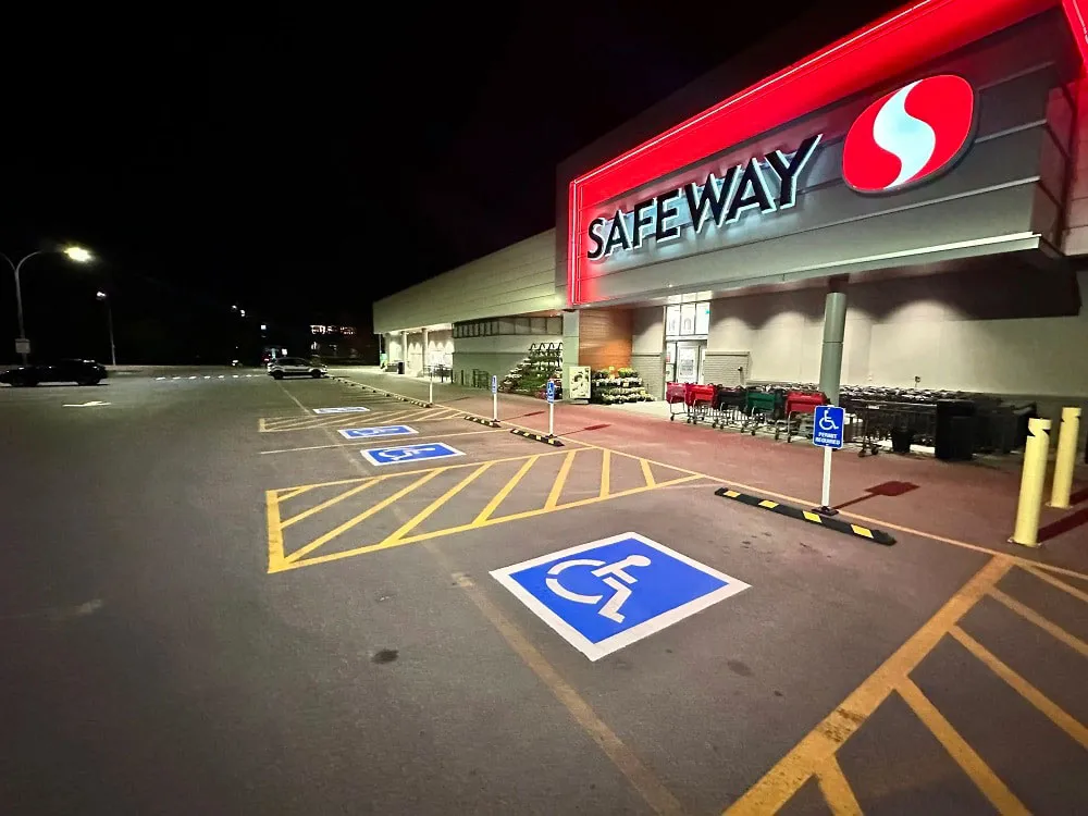 Safeway building and asphalt parking lot with line painting